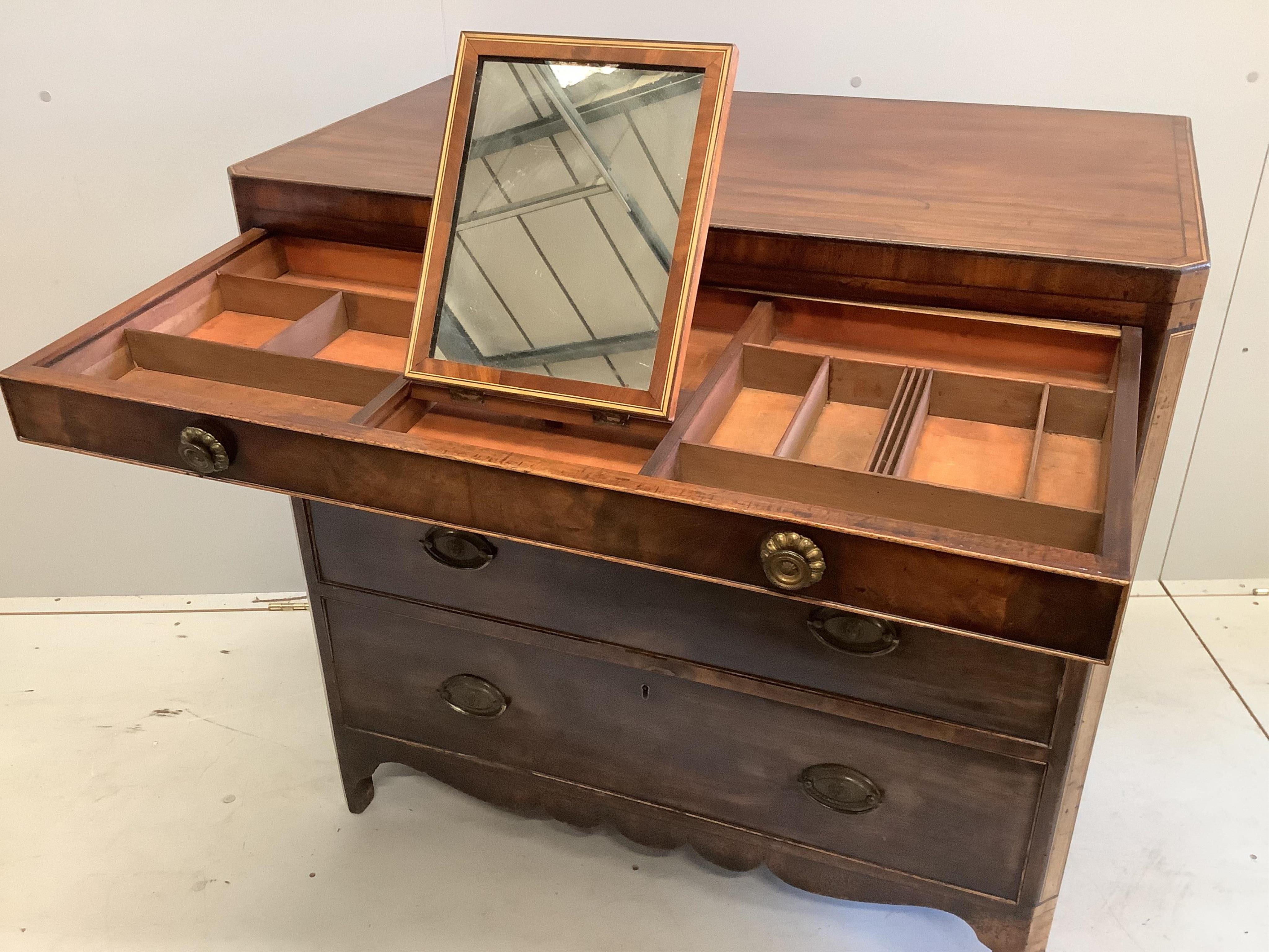 A George IV banded mahogany dressing chest, the fitted drawer with baize lined sliding surface and adjustable easel mirror, width 95cm, depth 51cm, height 92cm. Condition - fair